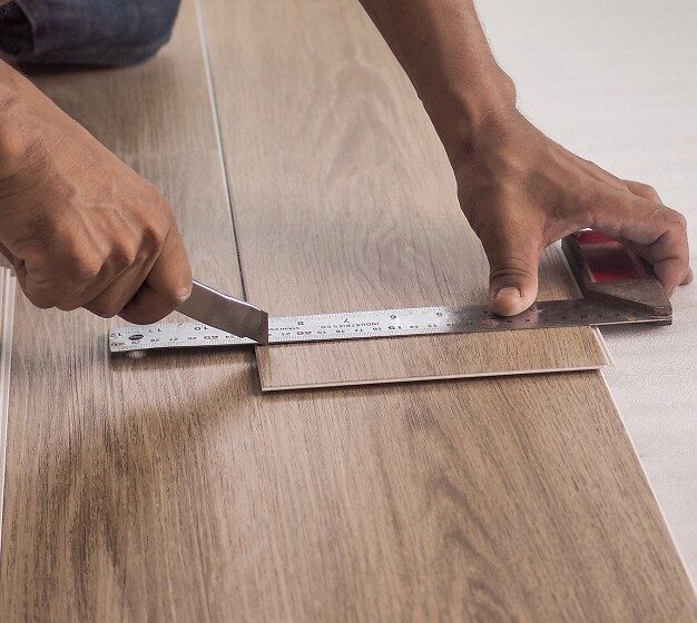 Flooring professional installing laminate
